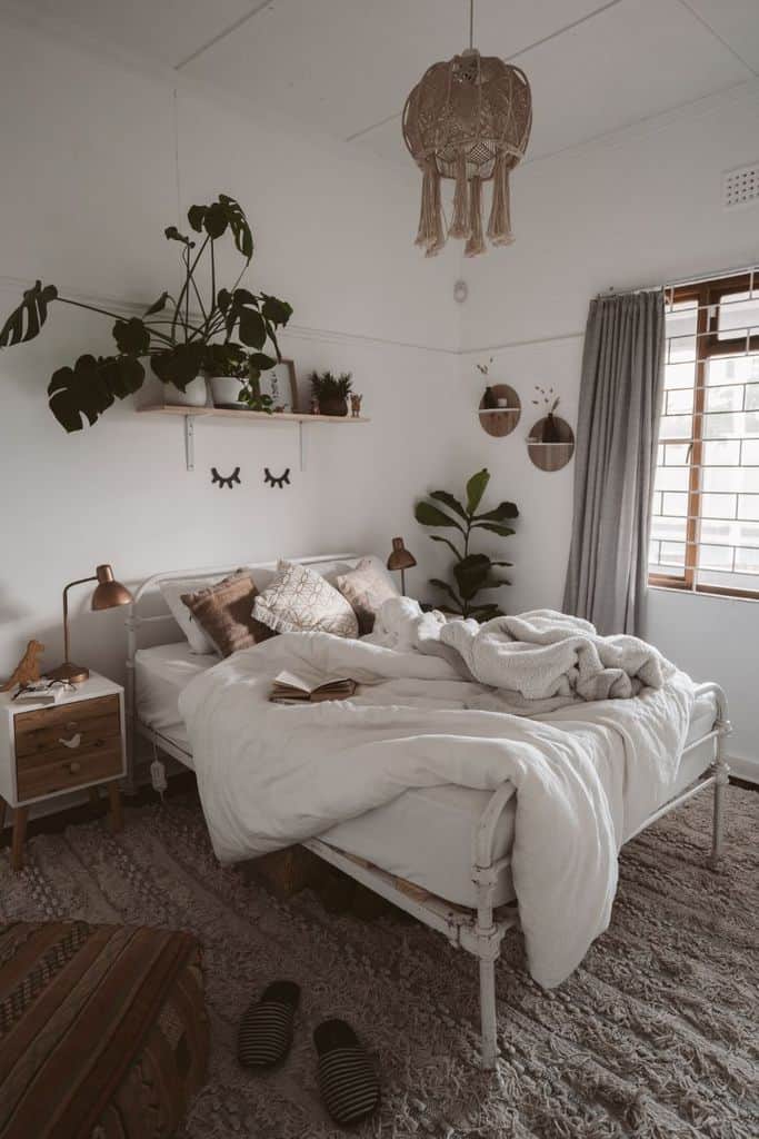 small apartment boho bedroom plants white iron bed frame 