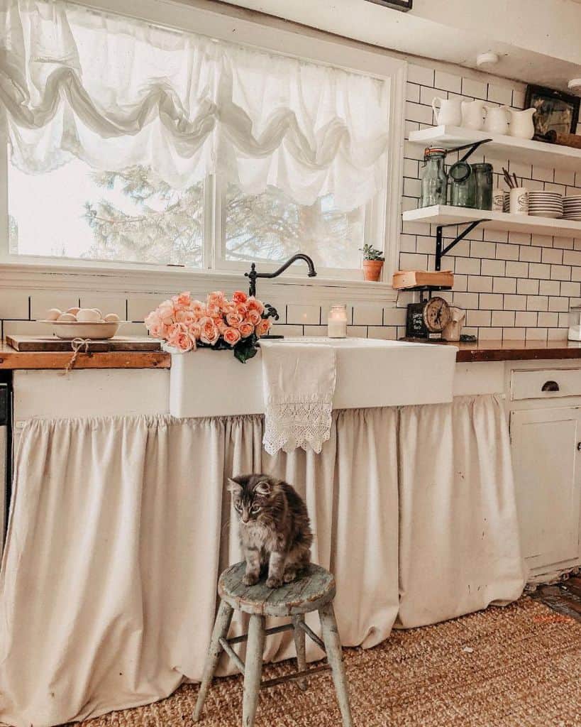 apron sink french country kitchen white tile splashback roses cat on stool