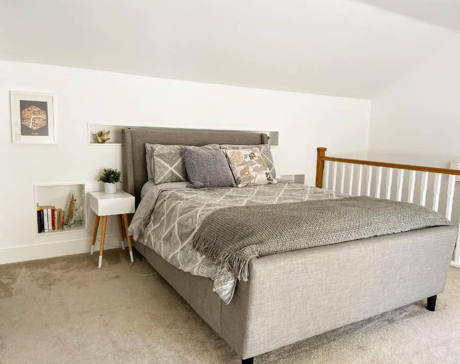 modern attic bedroom gray bed frame carpet floor small white bedside table 