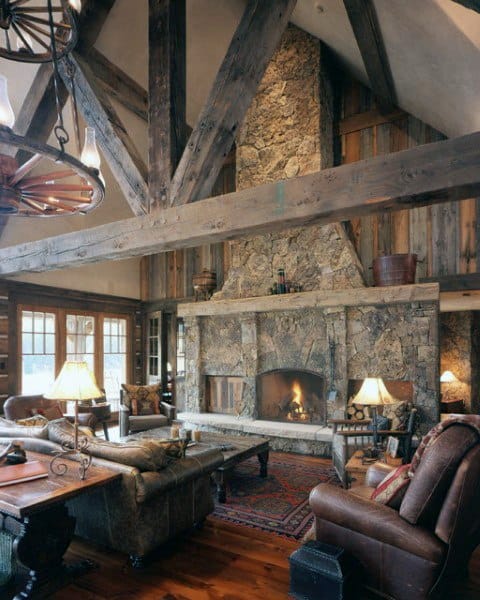 rustic wood cabin living room stone fireplace leather sofa 