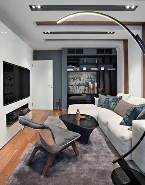 living room l-shape white sofa black coffee table recessed wall tv