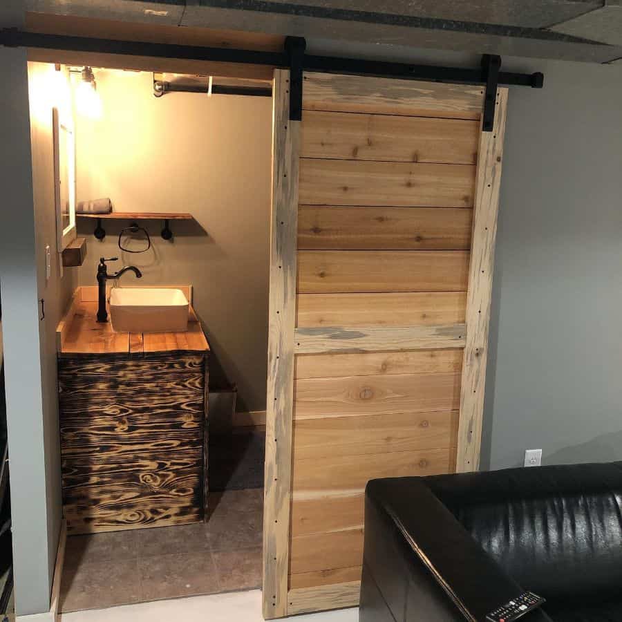 basement bathroom with wooden slide door