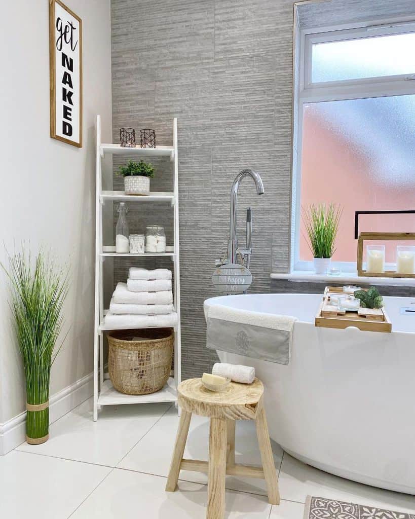 white bathroom rack textured gray wall white bathtub
