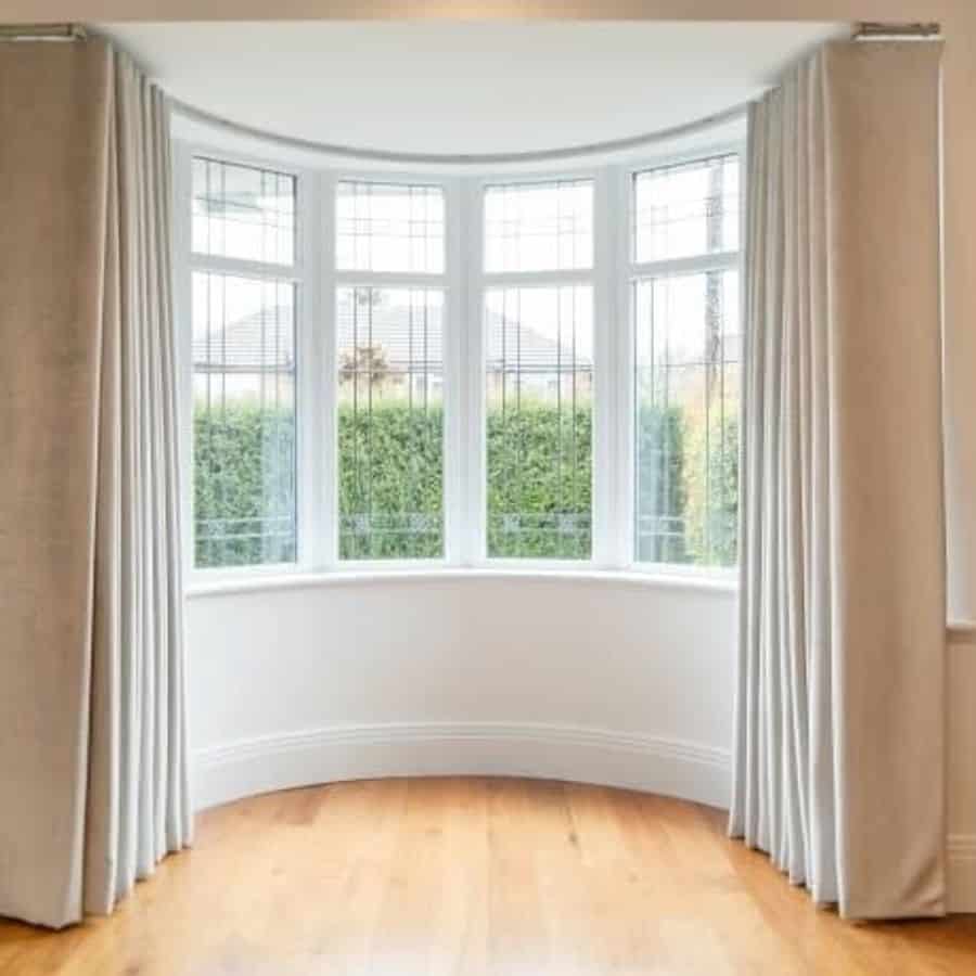 bay window living room cream curtains