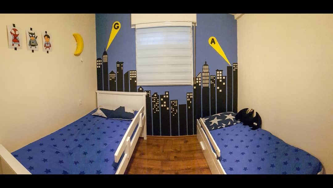 twin bedroom with city skyline wall art 