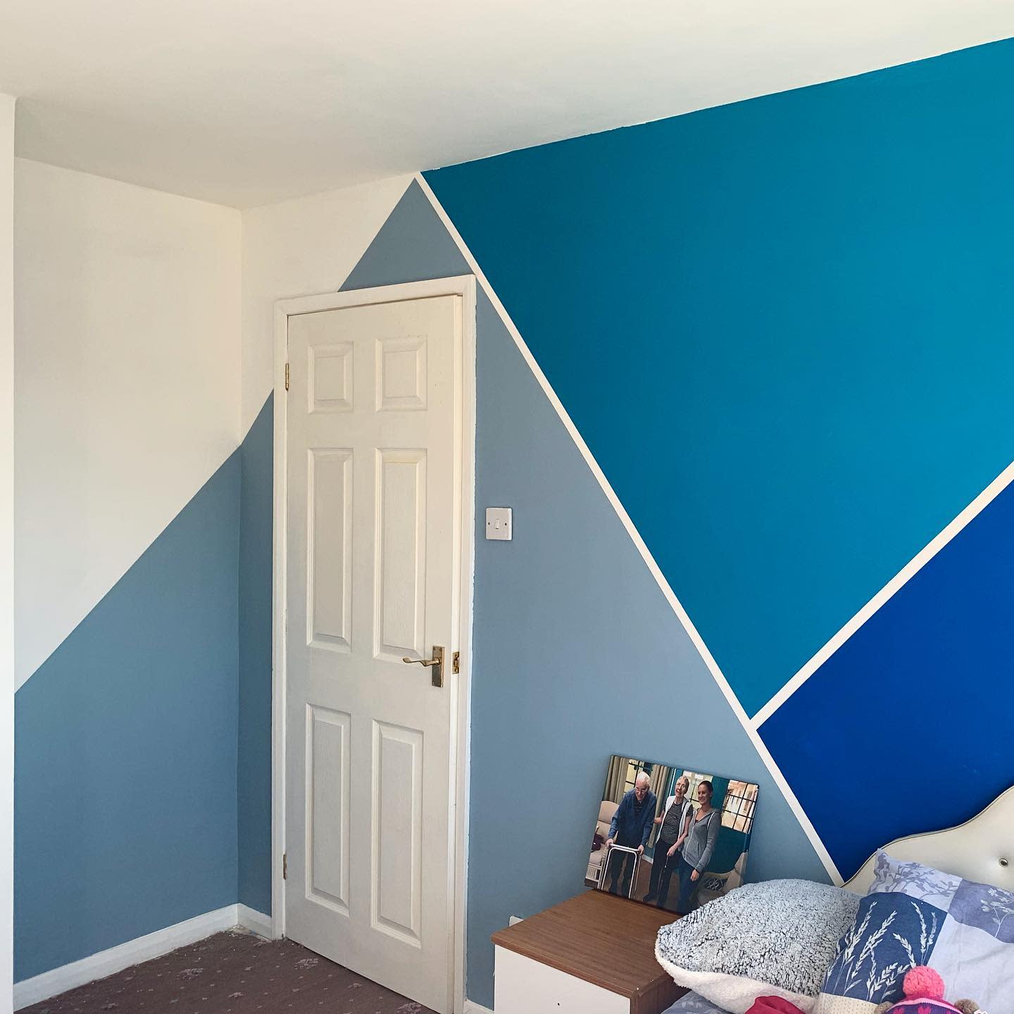 blue triangles painted on bedroom wall 