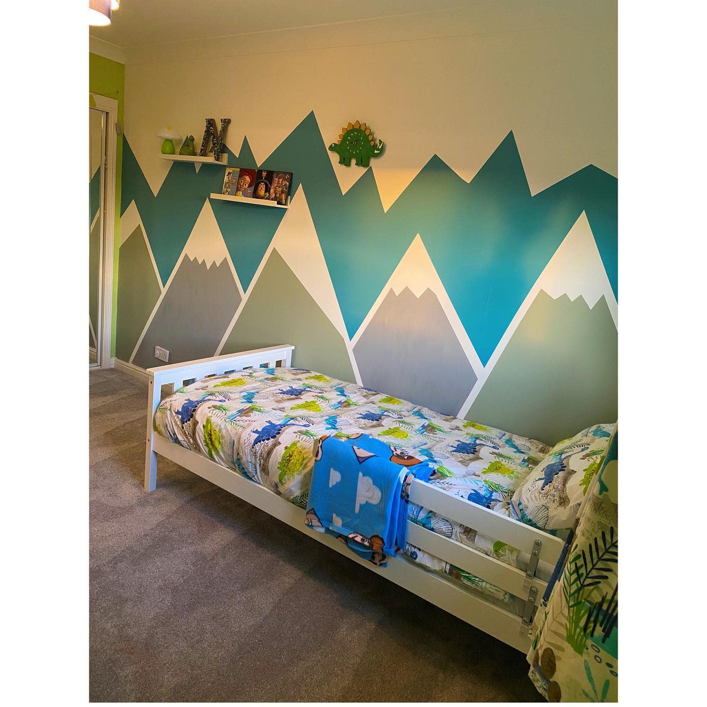 playful mountain design painted on kids bedroom wall