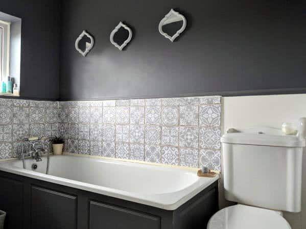 pattern tiles in master bathroom with black tub