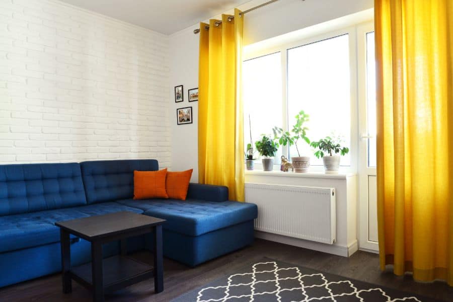 yellow curtains and blue sofa living room 