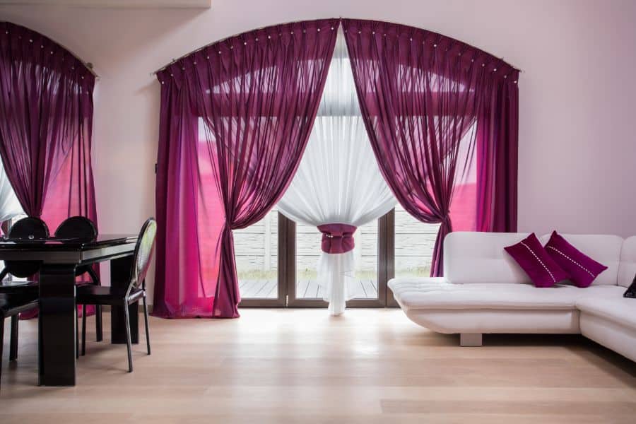 purple curtains living room with white sofa and black dining table 