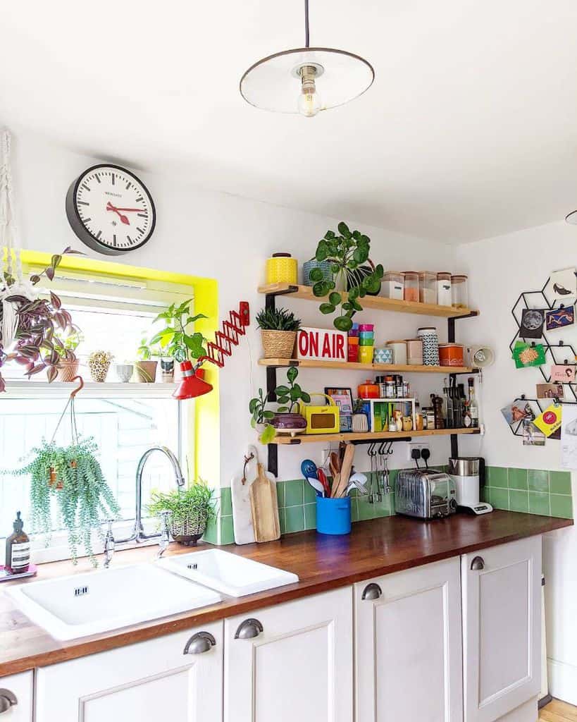 colorful kitchen white cabinets cluttered floating shelves green tiles 