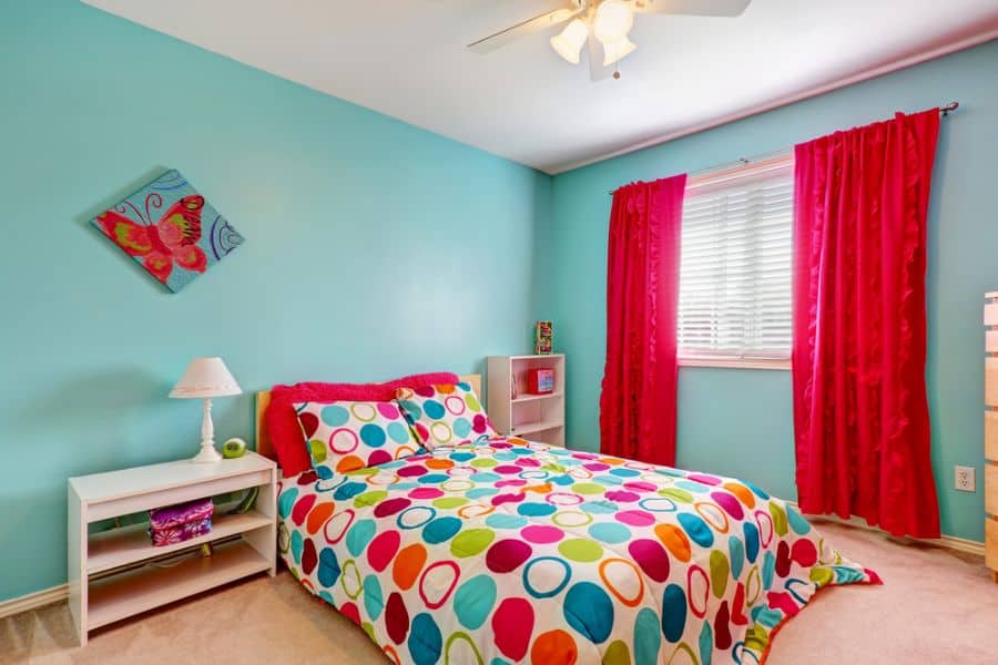light blue kids bedroom colorful bed red curtains 