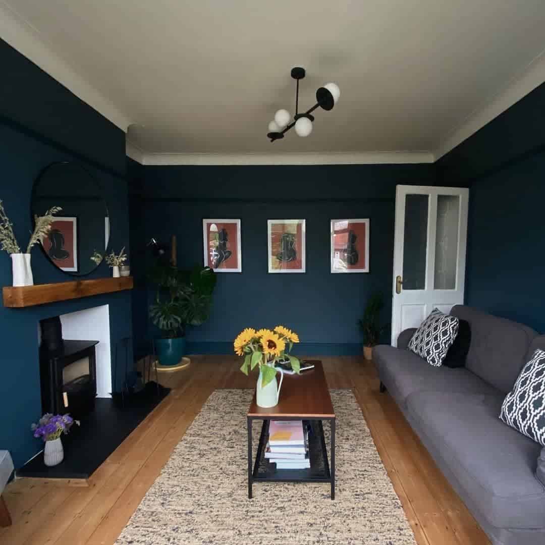 blue wall living room gray sofa