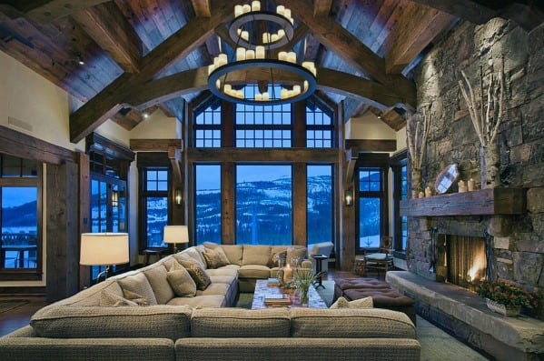 rustic cabin style living room giant gray sofa and stone fireplace 