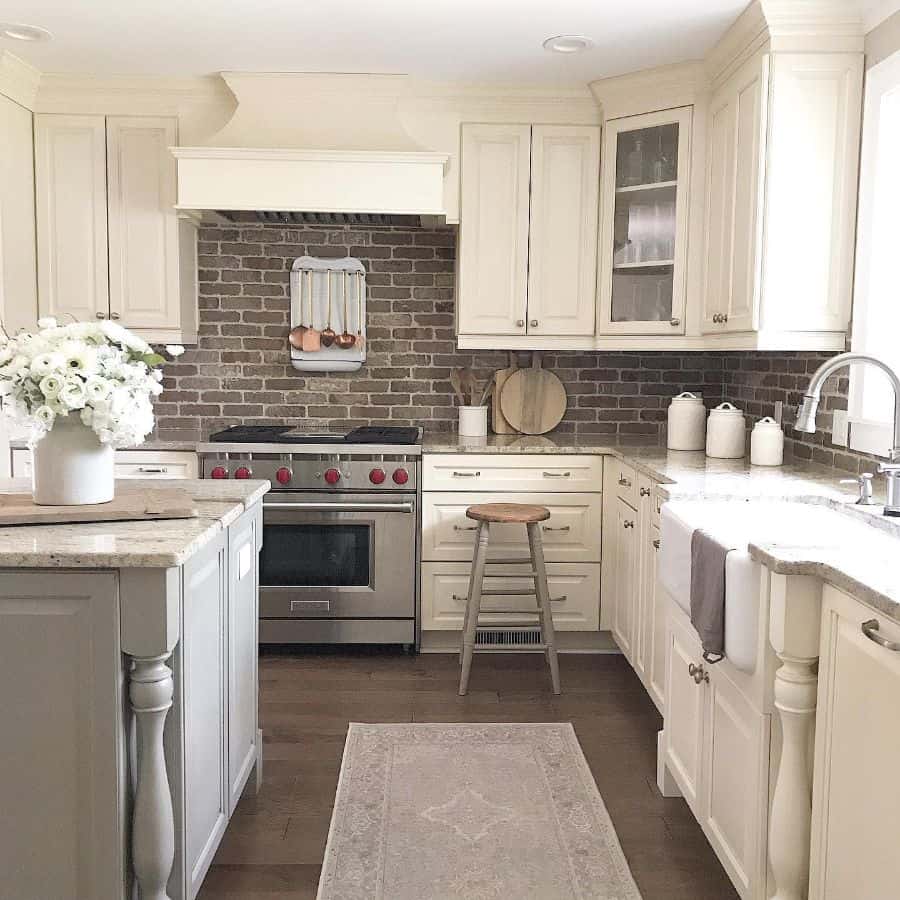 classic white french kitchen brick splashback gray island marble countertop