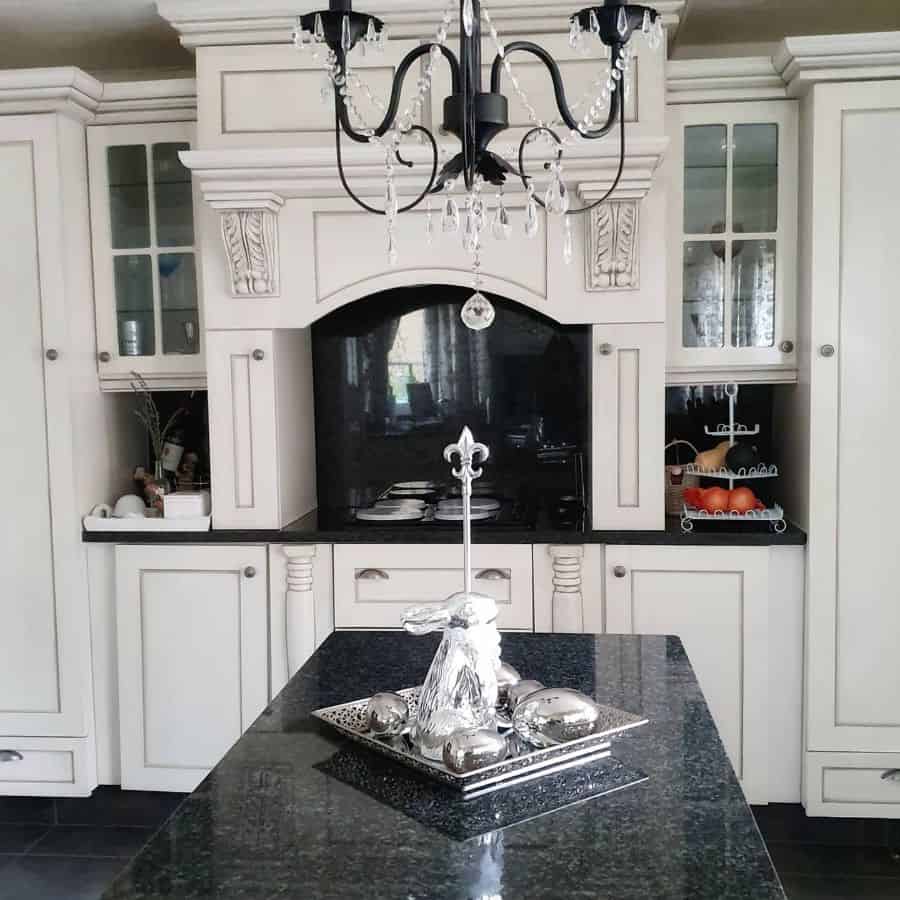 classic french country kitchen black granite splashback black chandelier black marble bench top 