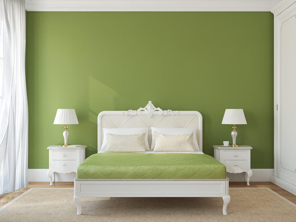 classic bedroom green accent wall elegant white bed frame and bedside tables 