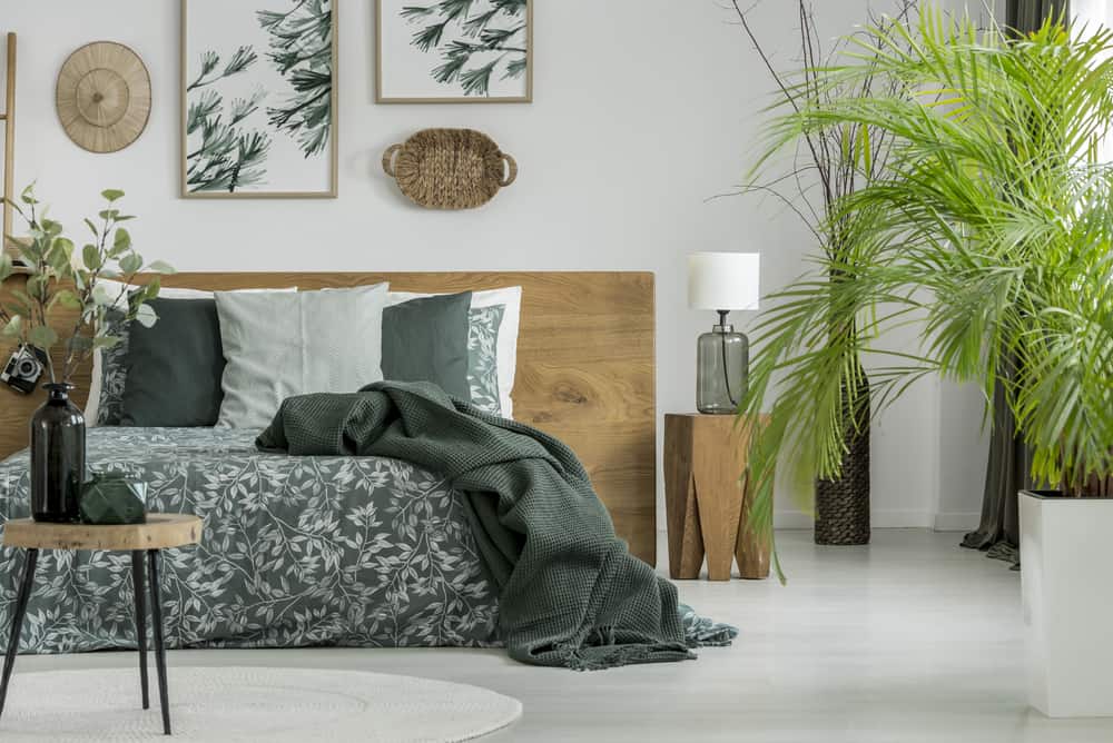 elegant bedroom wood platform bed framed wall art vase with plants 