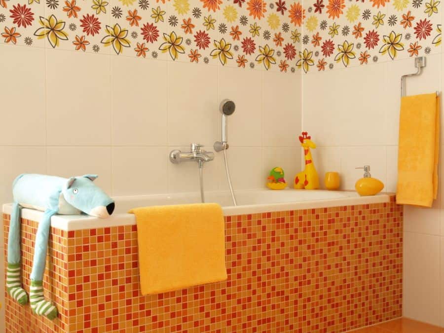 orange mosaic tile bathtub floral wall tiles yellow towels 
