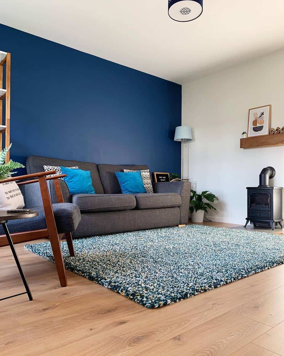 blue accent wall living room gray sofa