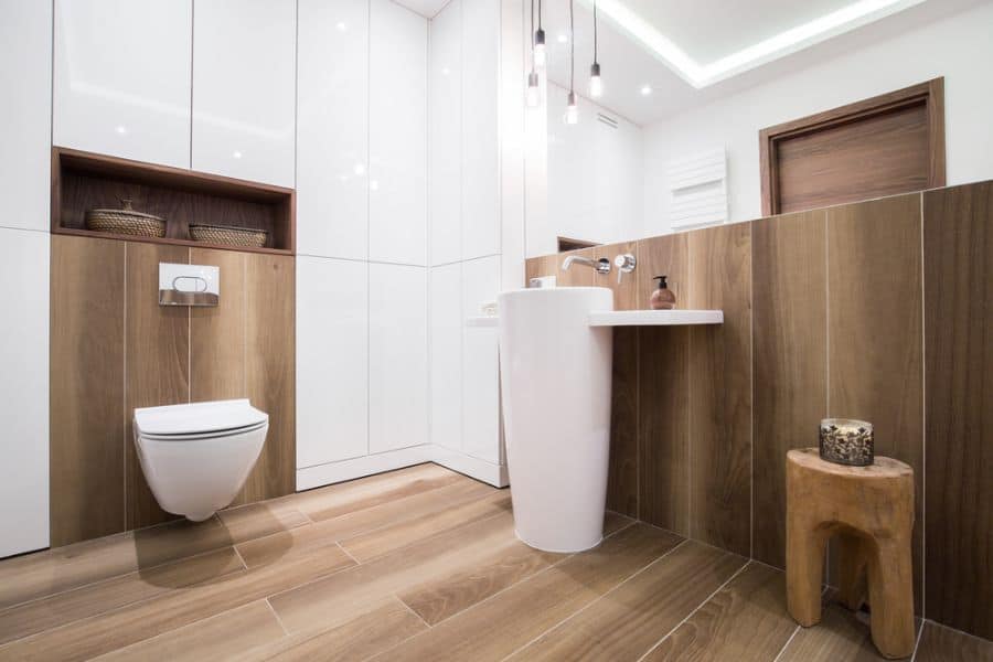 contemporary powder room with floating toilet and wood panels 