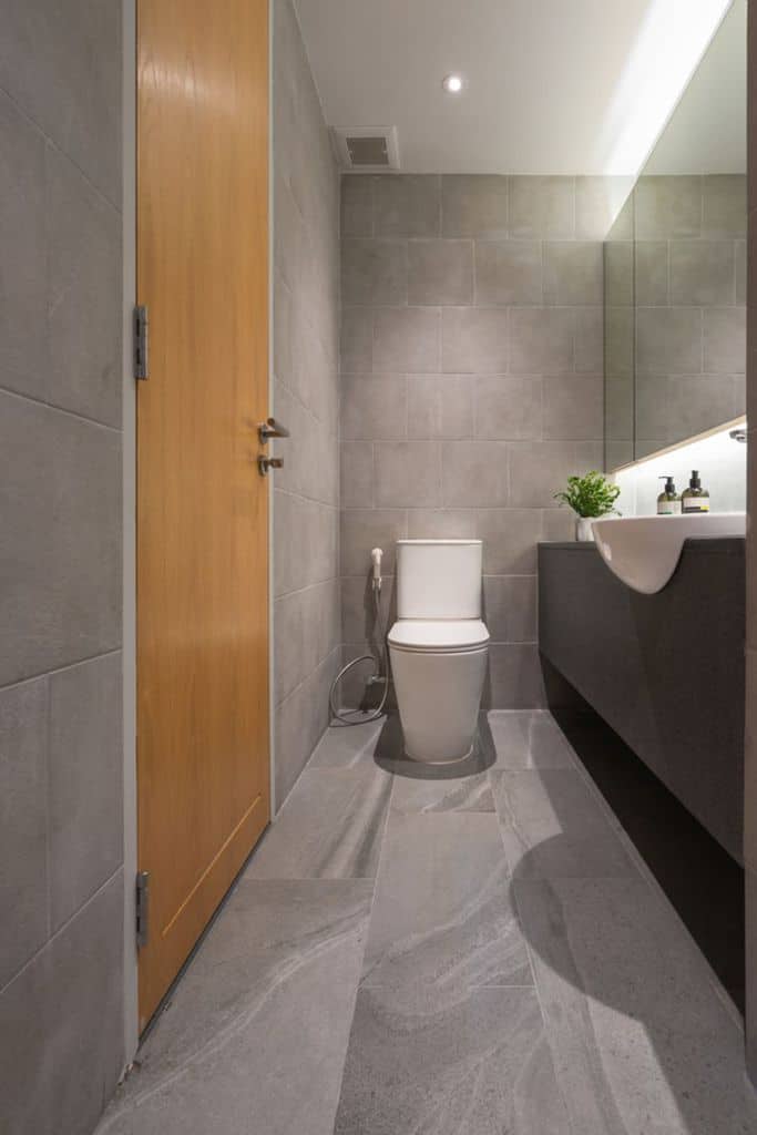 narrow contemporary powder room with gray tiles
