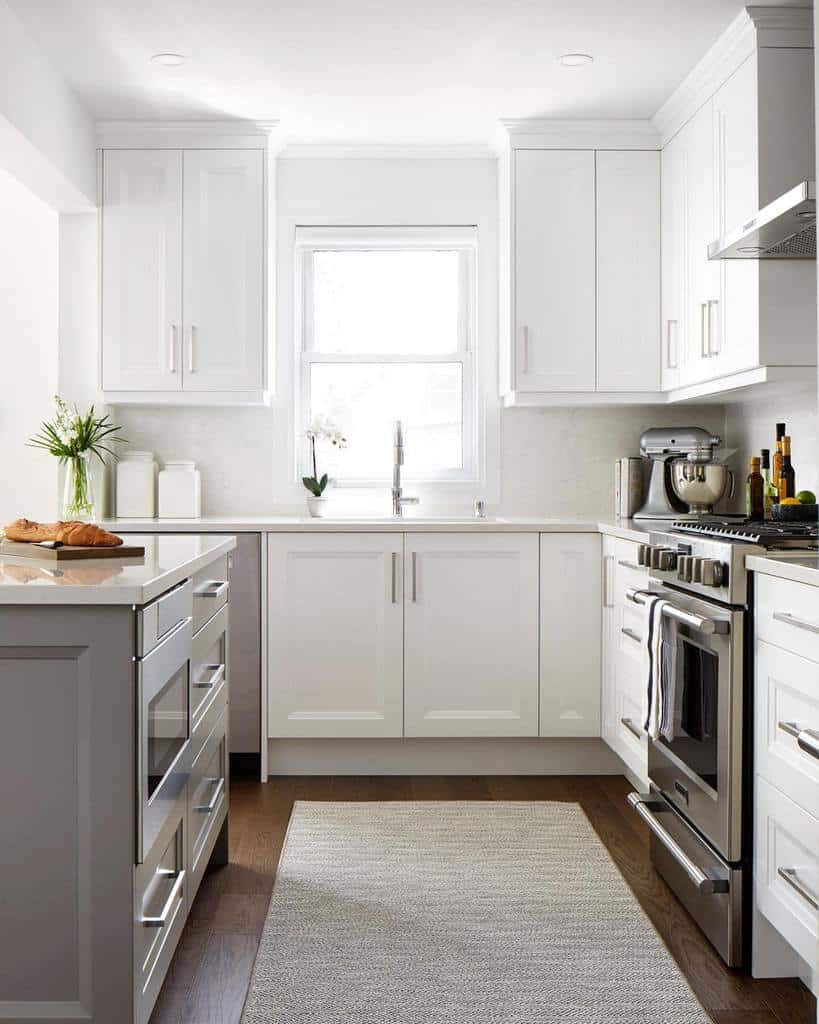 white kitchen cabinets steel appliances gray floor rug 