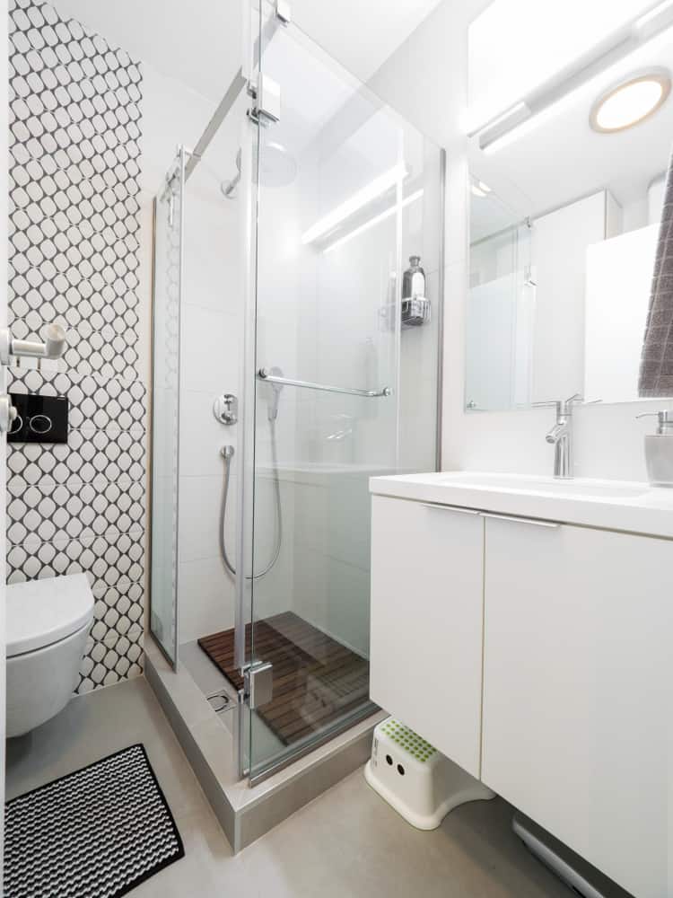 glass shower in small white bathroom 