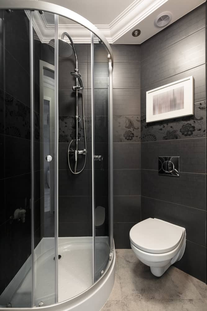 black tile bathroom with corner shower 