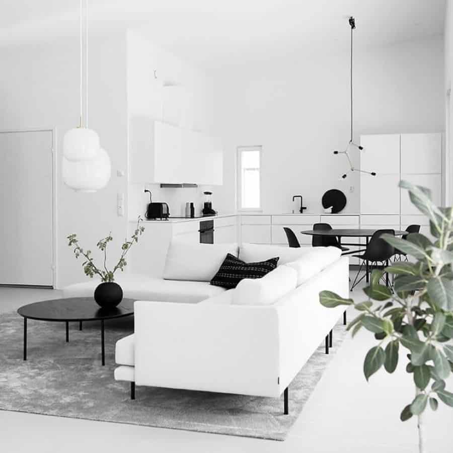 white living room with black dining table and chairs 