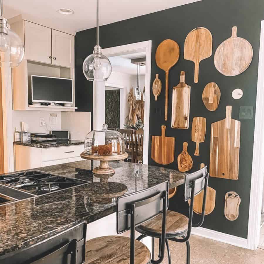cutting boards hanging on green accent wall kitchen 