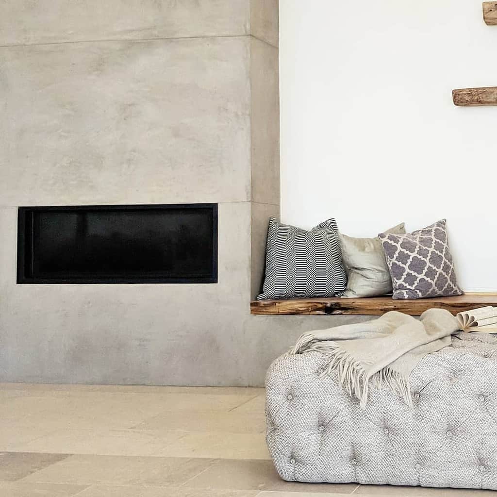 minimalist cement electric fireplace recessed wood bench seating 