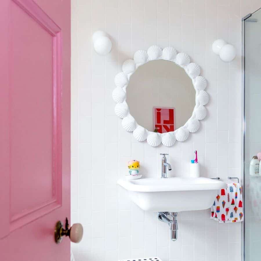 white tile bathroom floating sink pink door 
