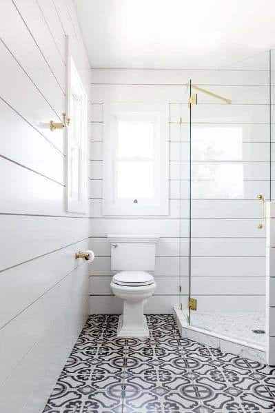 white shiplap wall master bathroom with corner shower and pattern floor tiles