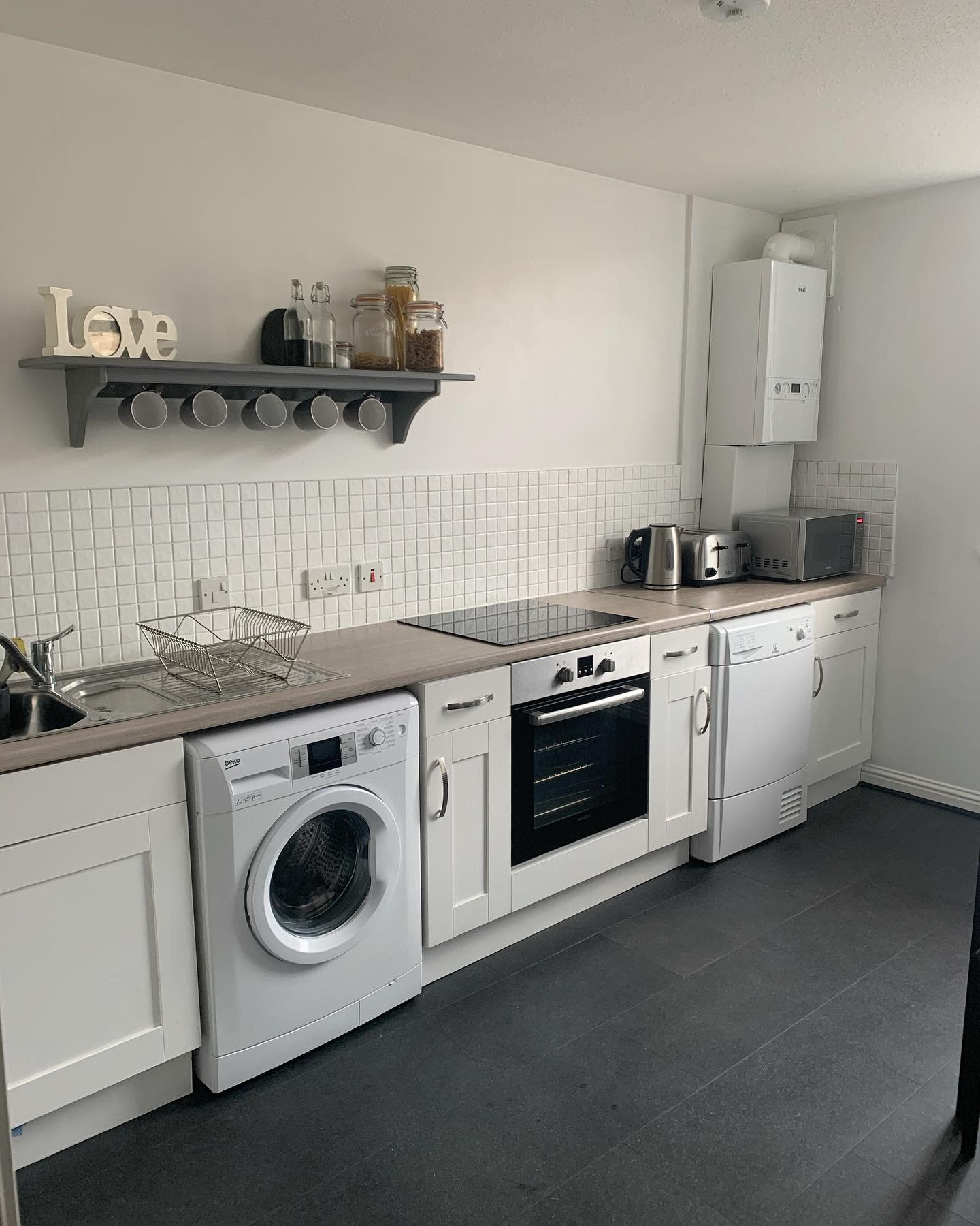 modern white kitchen and laundry combo