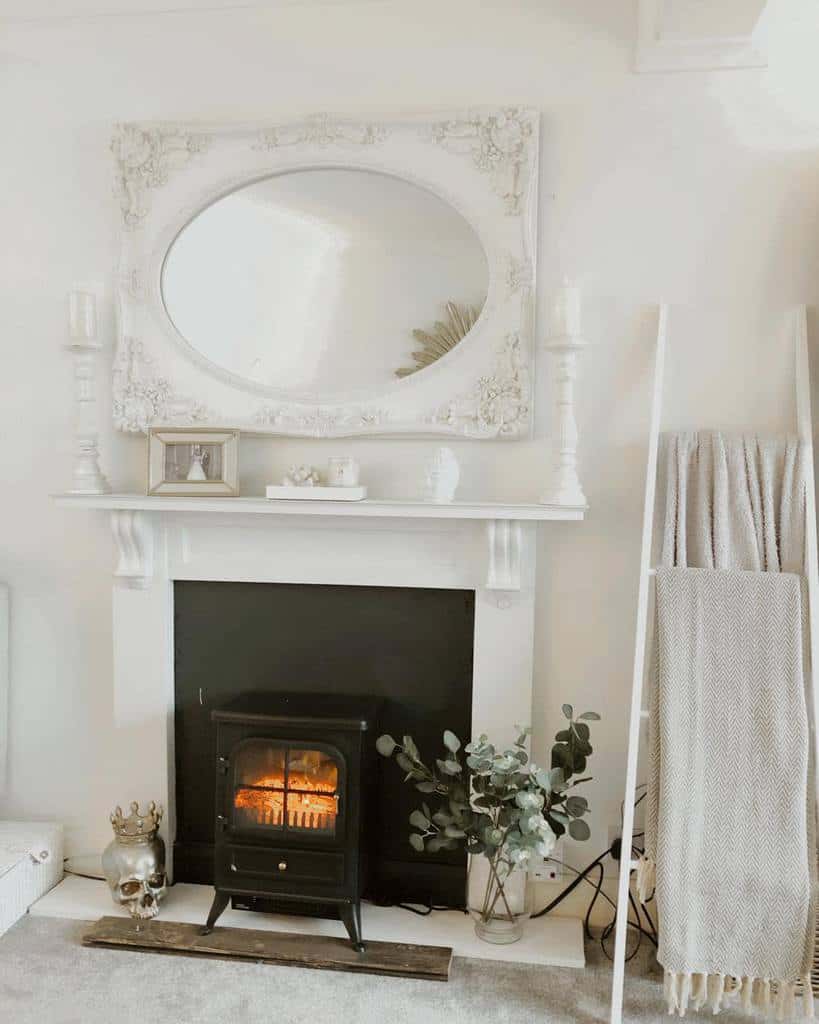 all white living room with fireplace wall mirror candlesticks decorative ladder 