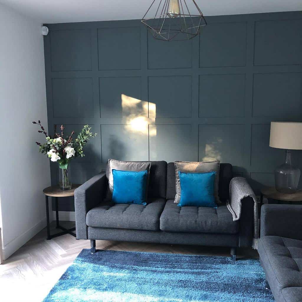 gray wood paneling wall living room gray sofa 