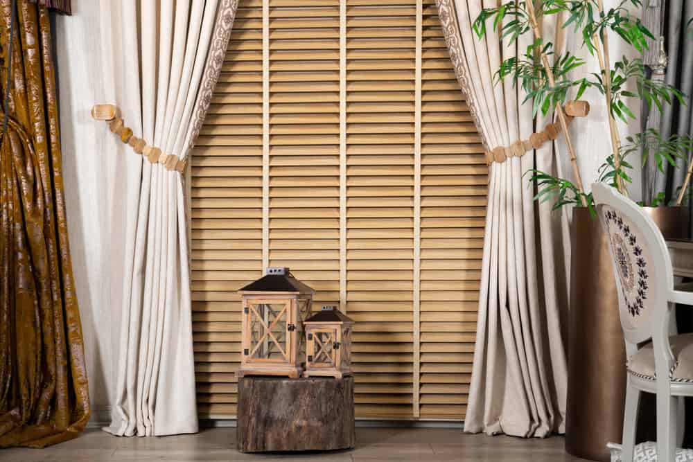 thick drapes and wood blinds floor lanterns 