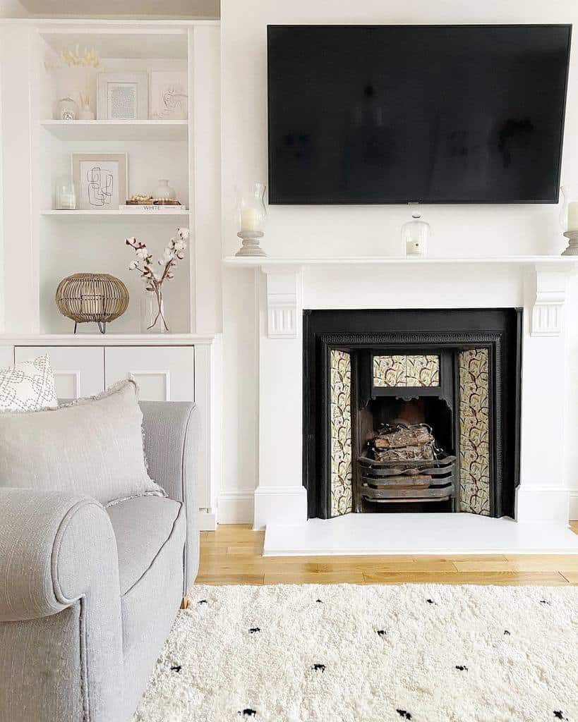 white living room fireplace wall mounted tv gray sofa chair 