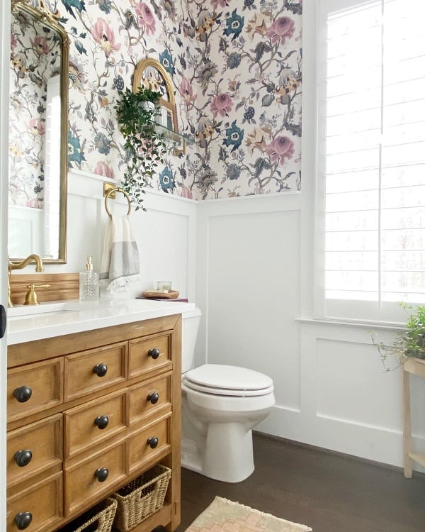 powder room with floral wallpaper and wood cabinet 
