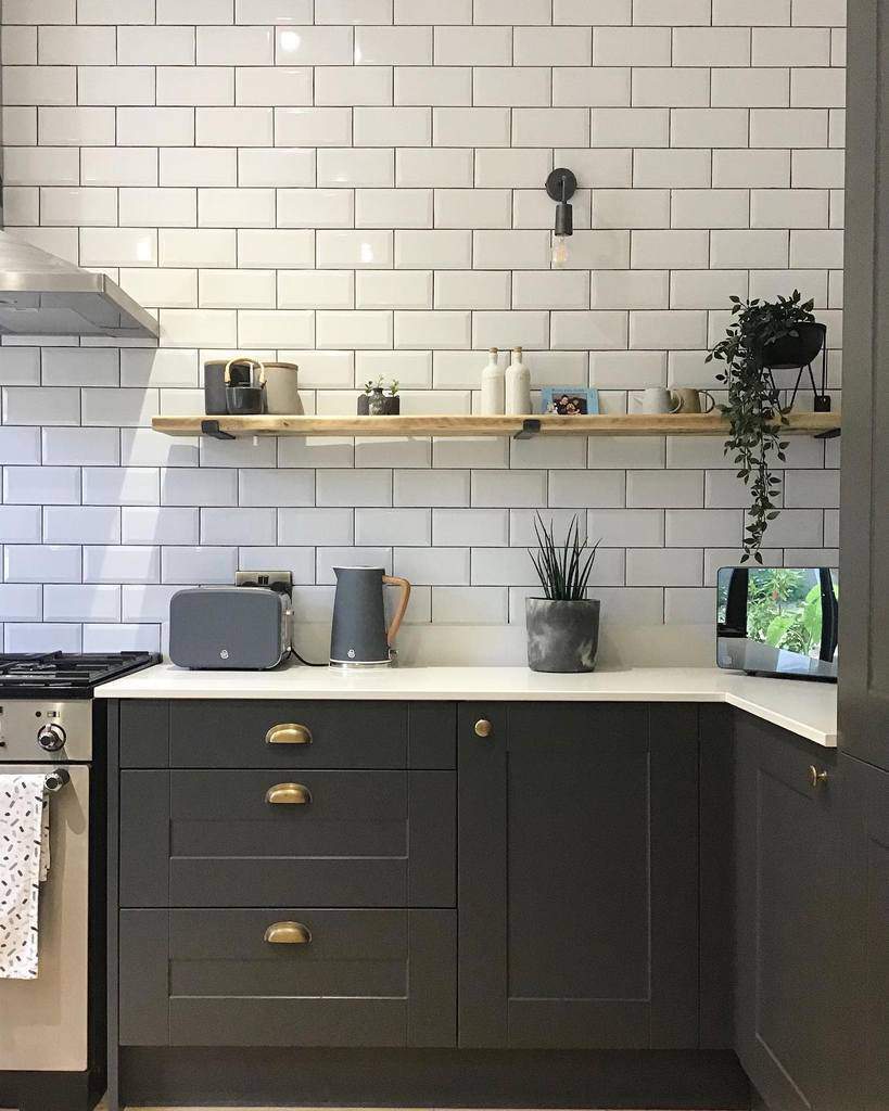 white subway tiles wood hanging shelf kitchen 