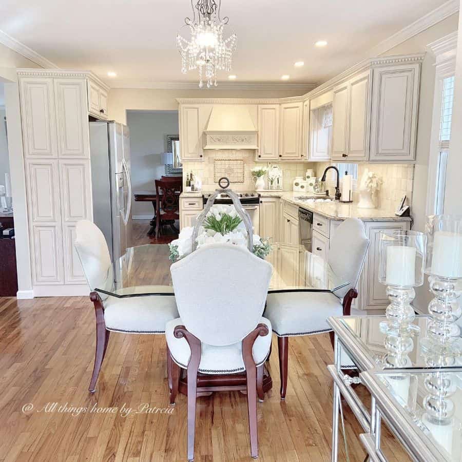 chic french country kitchen white cabinets glass table white chairs chandelier