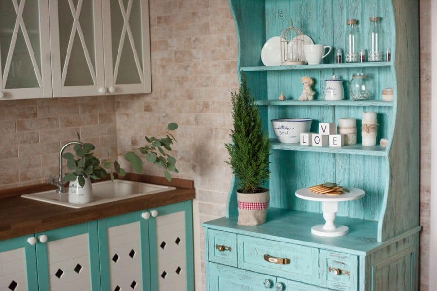 brick wall turquoise cabinet with shelves wood countertop sink 