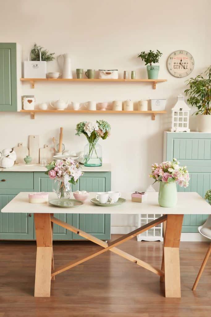 french country chic kitchen green cabinets wood wall shelves flowers 