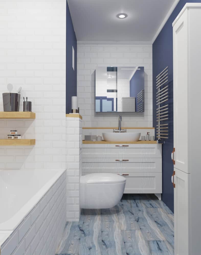 white tile and blue wall master bathroom with tub and floating toilet 