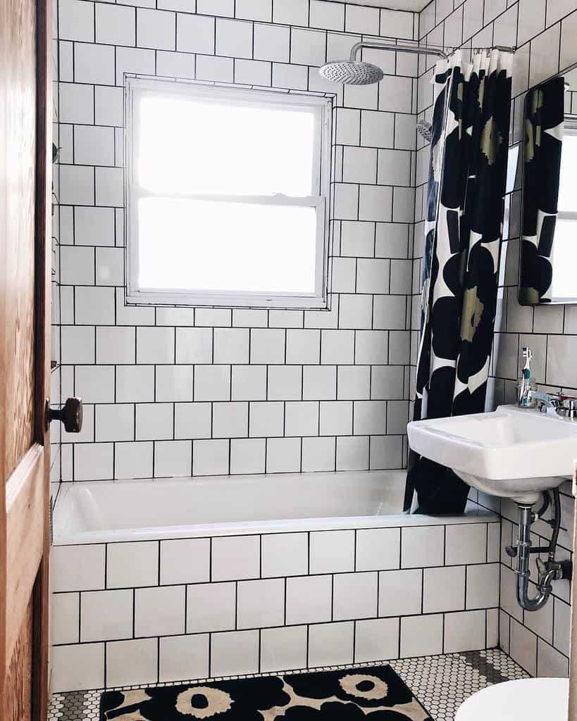 white tile bathroom with shower bathtub combo 