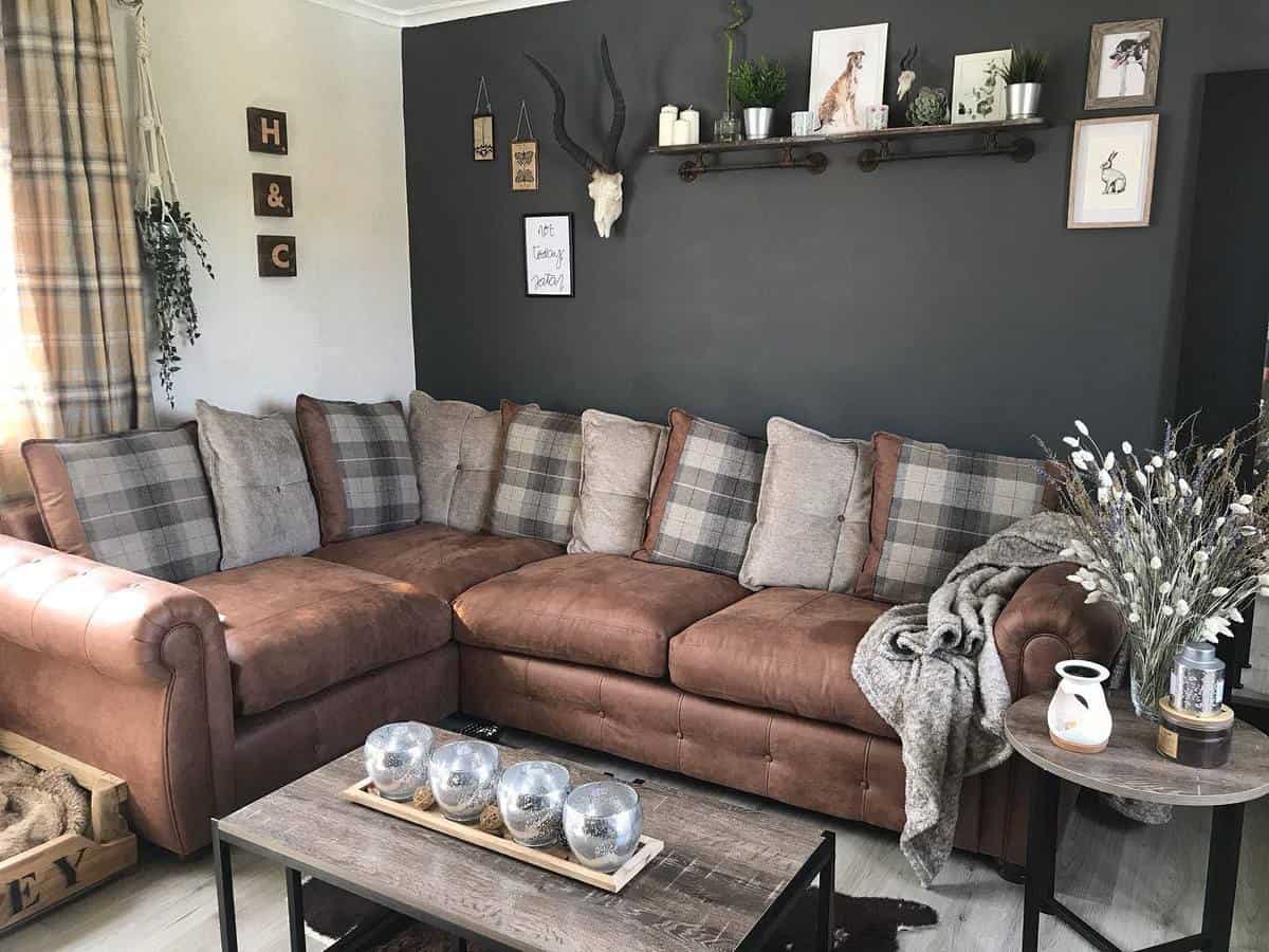 gray accent wall brown couch rustic living room