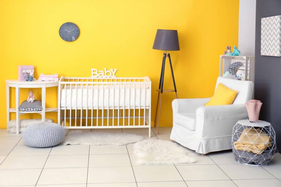yellow feature wall in baby's room