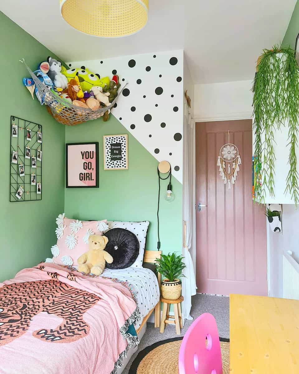 girls bedroom green feature wall pink door toy hammock photo wall