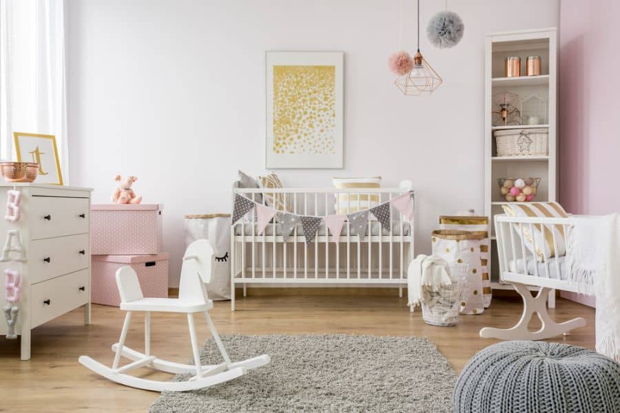 girl's baby room with rocking horse